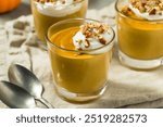 Sweet Homemade Pumpkin Pudding with Whipped Cream and Pecans