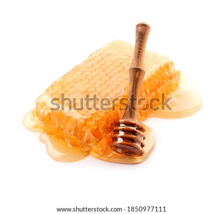 Sweet honeycomb with honey dripping in closeup on white backgrounds. [[stock_photo]] © 