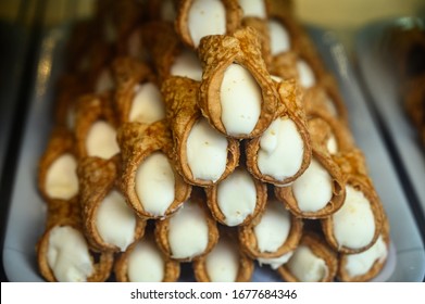 Sweet italian desssert, pile of cannoli pastry filled with ricotta cream cheese close up