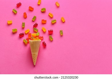 Sweet jelly bears and waffle cone on pink background