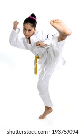 Sweet Latin Little Girl Stretching Leg In Martial Arts Practice Training Kick And Attack In Plastic Action Like Karate Kid  Isolated On White Background