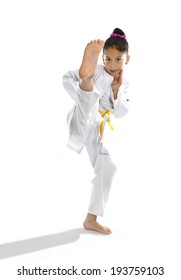 Sweet Latin Little Girl Stretching Leg In Martial Arts Practice Training Kick And Attack In Plastic Action Like Karate Kid  Isolated On White Background