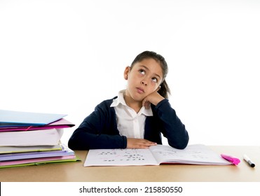 Sweet Little Female Hispanic Child Studying On Desk Looking Bored And Under Stress Thinking With A Tired Face Expression In Children Education And Back To School Concept Isolated On White Background