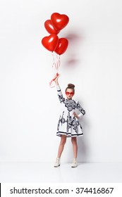 Sweet Little Girl In Nice Dress Holding Heart Shaped Balloons, Red Glasses