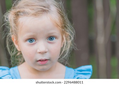 Sweet little girl, three years old. The girl smiles, looks into the camera. blonde girl with Blue eyes.Concept: summer, holidays, happy childhood.Little girl looks at the camera - Powered by Shutterstock
