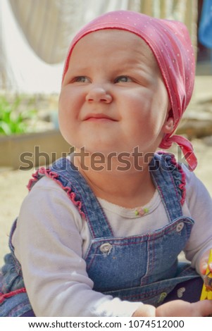 Similar – beautiful baby looking very funny into the the camera