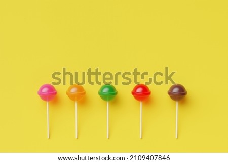 Sweet lollipop candy on pastel color background.