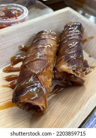 Sweet Lumpia With Caramel Drizzle In Wooden Try