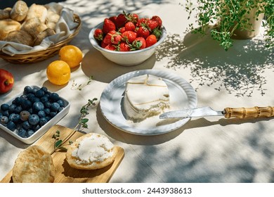 Sweet mini sandwiches for healthy breakfast in the garden. Toast with cream cheese, blueberry, strawberry, coconut flakes and herbs for summer picnic or brunch - Powered by Shutterstock