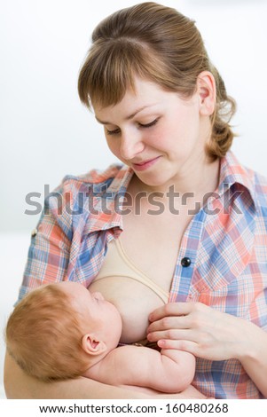 Similar – Image, Stock Photo young mother breast feeding her baby girl outdoors in a park