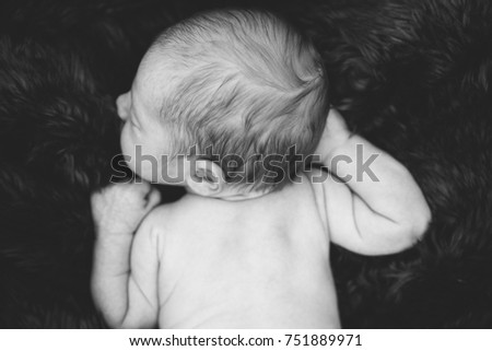 Similar – Newborn lying on the bed with her mother