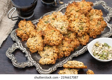 Sweet oatmeal cookies with sunflower seeds and pumpkin seeds served with coffee - Shutterstock ID 2196617087