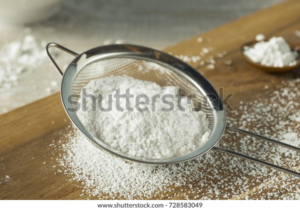 Sweet\
Organaic Confectioners Powdered Sugar in a\
Sieve