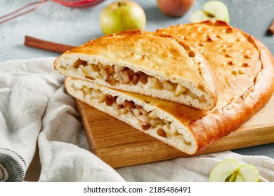 Sweet pastry - pie with apple and pear on concrete background. Apple pie in rustic style on wooden board. Composition with apple pie. Homemade pie with pear on gray table