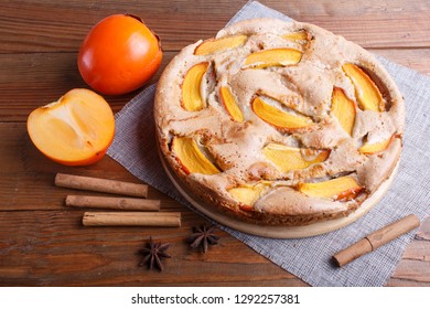 Sweet Persimmon Pie On Brown Wooden Background. Close Up.