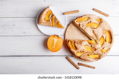 Sweet Persimmon Pie On White Wooden Background. Top View, Copy Space.