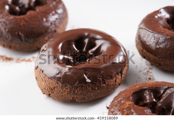 Sweet pieces of chocolate doughnuts with\
chocolate coating