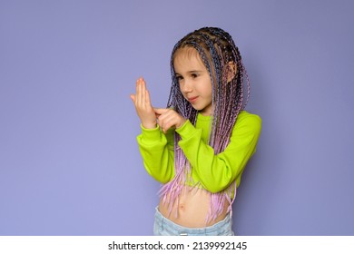 A Sweet, Pleasant Girl With Colored Afro Pigtails Writes With Her Finger On The Palm Of Her Hand. The Child Dials The Phone Number On Hand Not For Real