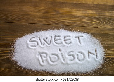 SWEET POISON Written On Sugar On Brown Wooden Table. Health Concept