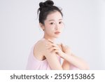 Sweet portrait of a beautiful young Asian woman with pink nails