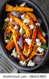 Sweet Potato Fries With Feta Cheese And Red Onion.  In Rustic Oval Black Dish.