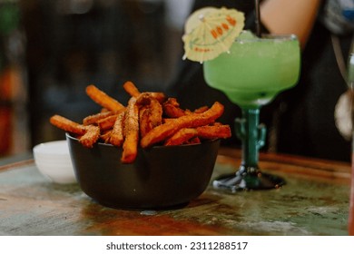 Sweet potato fries and green cocktail - Shutterstock ID 2311288517