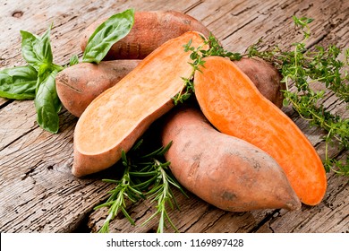 Сладкий картофель на деревянном фоне