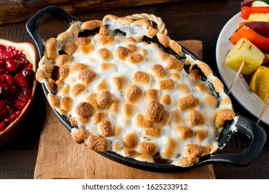 Sweet Potatoes Or Candied Yams. Classic American Thanksgiving Side Dish. Served With Toasted Marshmallows, Cheese, Garnished With Scallions And Italian Parsley And Served In Cast Iron Skillet. 