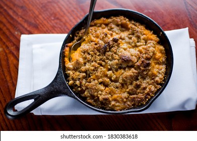 Sweet Potatoes Or Candies Yams With Toasted Marshmallows Topped With Cheese Cream, Garnished W/ Scallions And Italian Parsley & Served In Cast Iron Skillet . Classic American Thanksgiving Side Dish.