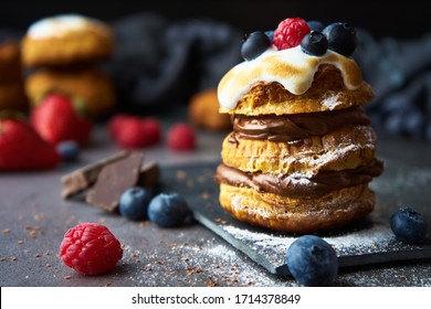 Sweet puff pastry with chocolate filling and accompanied by blueberries and raspberries