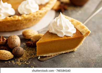 Sweet pumpkin pie slice decorated with whipped cream