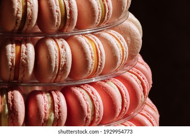 Sweet pyramid of the french macarons or macaroon for the birthday, event or wedding on black background. selective focus. copy space