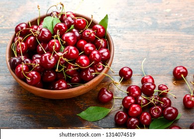 sweet red cherries in a plate on a wooden background. space for text