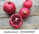 Sweet red pomegranate on a wooden table