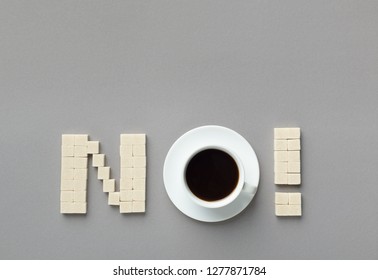 Sweet Refuse. Sugar Cubes And Cup Of Coffee Arranged As Word NO On Gray Background, Top View, Copy Space
