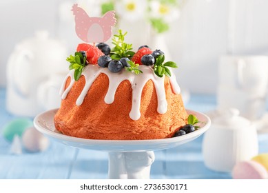 Sweet ring cake for Easter with lemon icing and fruit. Traditional polish easter dessert.