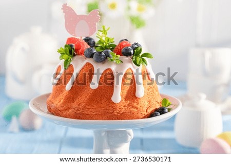 Sweet ring cake for Easter with lemon icing and fruit. Traditional polish easter dessert.