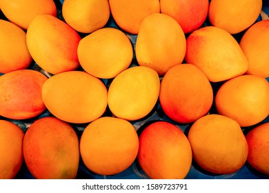 Sweet Ripe Mangoes Piled In A Tray On The Market