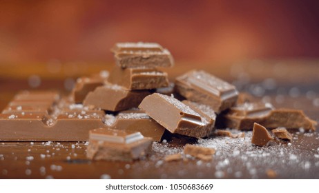 Sweet And Salty Chocolate Snacks, Salted Caramel Bar, Macro Close Up On Rustic Wood Background.