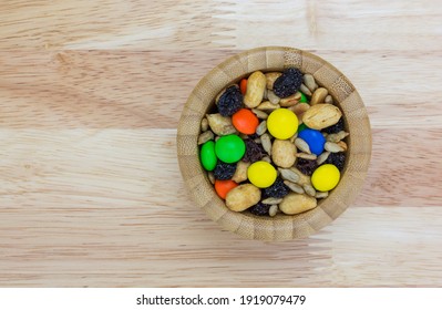 Sweet And Salty Trail Mix In A Bowl On A Wood Tabletop Overhead View.