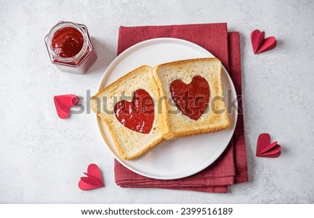 Sweet sandwiches with strawberry jam with heart shape inside for Valentine's day holiday. toning