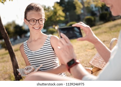 So Sweet. Shy Teenager Keeping Smile On Her Face And Bowing Head While Standing Opposite Her Mom