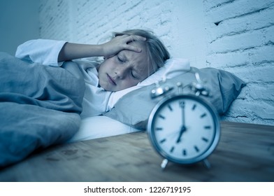 Sweet Sleepless Little Girl Lying Sad In Bed Looking At Alarm Clock Having To Wake Up But Feeling Tired Sleepless In Troubles Staying Asleep Night Terrors Sleep Disorder And Children Insomnia Concept.