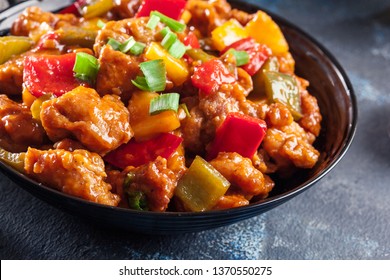 Sweet and sour chicken with colorful bell pepper on a plate. Chinese dish