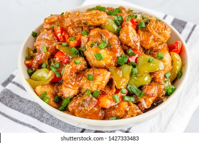 Sweet And Sour Chicken In A White Bowl. American Chinese Cuisine, Close Up And Horizontal Photo.