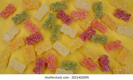 Sweet Sour Gummy Bears As Candy On Yellow Background