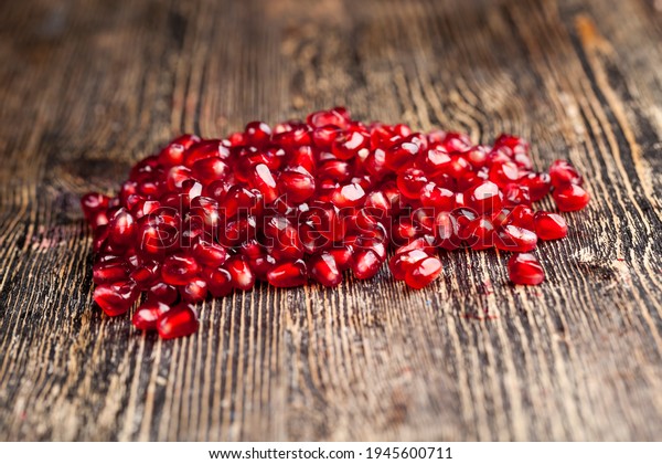sweet and sour taste of the healthy\
fruit of the pomegranate tree, the fruit is divided into parts with\
seeds, red delicious grains of ripe\
pomegranate,
