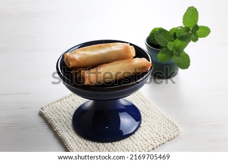 Sweet Spring Roll, Deep Fried Lumpia with Fruit and Banana Inside, on White Table