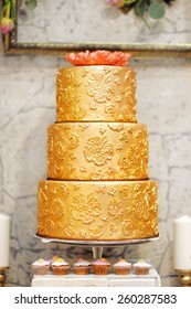 Sweet Table With Big Golden Cake 