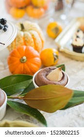 Sweet Table. Halloween Wedding Luxor Decor. Chocolate Cake, Pears. Surrounded By Orange Pumpkins